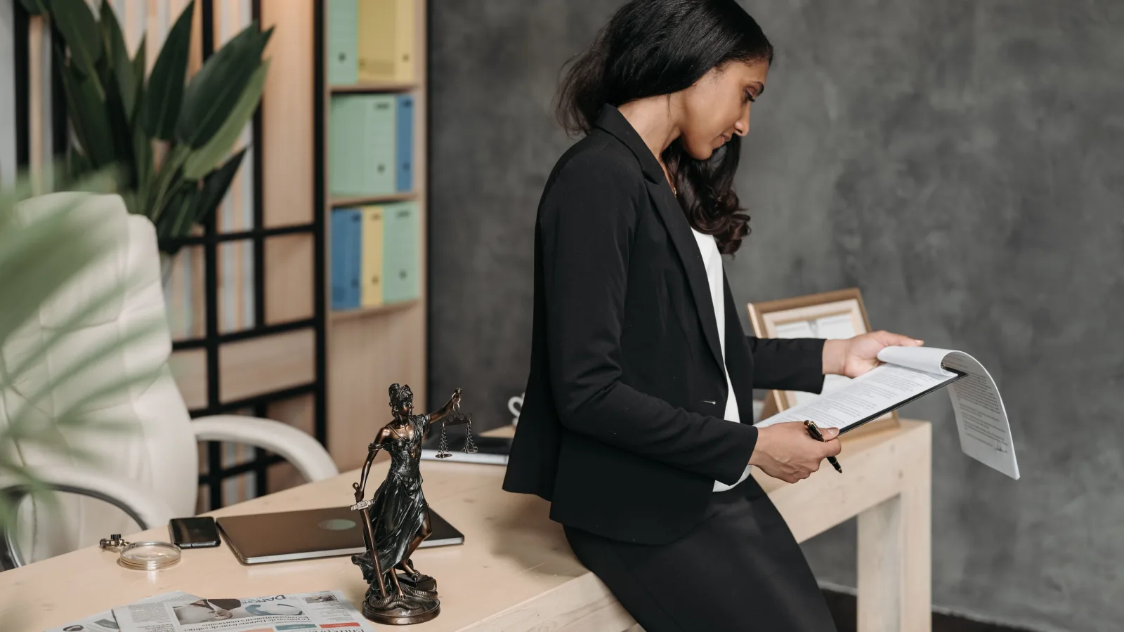 Professional reviewing legal documents at an office desk